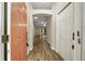 Bright entryway with coral door and wood-look floors at 131 Costa Mesa Dr, The Villages, FL 32159
