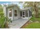 Grey patio with screened enclosure and mature landscaping at 131 Costa Mesa Dr, The Villages, FL 32159