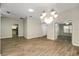 Dining room with chandelier and wood-look floors at 131 Costa Mesa Dr, The Villages, FL 32159