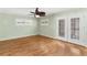Bright bedroom with wood floors, ceiling fan, and access to backyard at 6919 Fern Cir, Leesburg, FL 34748