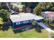 Blue house with white trim, landscaping, and a driveway at 6919 Fern Cir, Leesburg, FL 34748