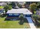 Blue house with white trim, landscaping, and a driveway at 6919 Fern Cir, Leesburg, FL 34748