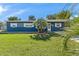 Charming ranch home with blue exterior and well-maintained lawn at 6919 Fern Cir, Leesburg, FL 34748