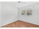 Simple bedroom with wood floors and large windows at 6919 Fern Cir, Leesburg, FL 34748