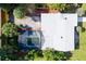 House with a screened-in pool and lush landscaping at 6919 Fern Cir, Leesburg, FL 34748