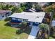 Blue house with white trim, landscaping, and a driveway at 6919 Fern Cir, Leesburg, FL 34748