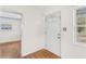 Bright entryway with hardwood floors and white door at 6919 Fern Cir, Leesburg, FL 34748