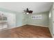Spacious bedroom with wood floors and view into adjacent room at 6919 Fern Cir, Leesburg, FL 34748
