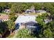 House with a screened-in pool and lush landscaping at 6919 Fern Cir, Leesburg, FL 34748