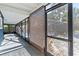 Screened porch with brown bamboo shades and access to backyard at 6919 Fern Cir, Leesburg, FL 34748