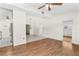 Open living room with hardwood floors and access to kitchen at 6919 Fern Cir, Leesburg, FL 34748