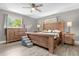 Main bedroom with large bed and hardwood floors at 37102 Oak Ln, Umatilla, FL 32784