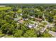 Aerial view showing home's location in a quiet residential neighborhood with lush green landscape at 37102 Oak Ln, Umatilla, FL 32784