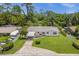 Single story house exterior with green lawn and driveway at 37102 Oak Ln, Umatilla, FL 32784