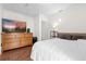 Bright bedroom with a large bed, dresser, and flat-screen TV at 37102 Oak Ln, Umatilla, FL 32784
