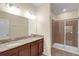Bathroom with double vanity, granite countertop, and large shower at 3603 Solana Cir # B, Clermont, FL 34711
