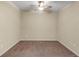 Empty bedroom with ceiling fan and neutral colored walls at 3603 Solana Cir # B, Clermont, FL 34711