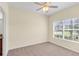 Bright bedroom with neutral walls, carpet flooring, and large window at 3603 Solana Cir # B, Clermont, FL 34711