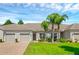 Two-car garage and lush landscaping at 3603 Solana Cir # B, Clermont, FL 34711