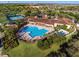 Community clubhouse with pool, tennis courts, and expansive green spaces at 3603 Solana Cir # B, Clermont, FL 34711