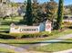 Elegant clubhouse entrance sign in a well-manicured landscape at 3603 Solana Cir # B, Clermont, FL 34711