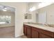 Double vanity bathroom with granite countertop and view of bedroom at 3603 Solana Cir # B, Clermont, FL 34711