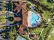 Community clubhouse and pool viewed from above, showcasing its layout and amenities at 3603 Solana Cir # B, Clermont, FL 34711