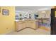 Open kitchen with granite island and view into dining area at 8084 Se 175Th Malmaison St, The Villages, FL 32162