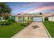 Charming single-story house with a well-manicured lawn and driveway at 8084 Se 175Th Malmaison St, The Villages, FL 32162