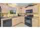 Well-equipped kitchen featuring granite countertops and wood cabinets at 8084 Se 175Th Malmaison St, The Villages, FL 32162