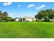 Spacious backyard with lush green grass and mature trees at 8084 Se 175Th Malmaison St, The Villages, FL 32162