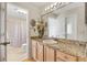 Bathroom with granite vanity and a shower/tub combo at 8084 Se 175Th Malmaison St, The Villages, FL 32162