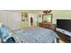 Second bedroom with dresser and access to another room at 8084 Se 175Th Malmaison St, The Villages, FL 32162