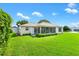 Large backyard with a screened porch and well-maintained lawn at 8084 Se 175Th Malmaison St, The Villages, FL 32162