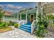 Enticing front view of a green house with blue steps and white porch at 348 E 10Th Ave, Mount Dora, FL 32757