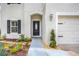 Inviting home exterior featuring a walkway, landscaping, and a two-car garage at 1103 White Water Bay Dr, Groveland, FL 34736