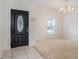 Bright and airy entryway with tile flooring and a view of a window with plantation shutters at 1103 White Water Bay Dr, Groveland, FL 34736