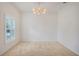 Spacious dining room with neutral carpeting and a lovely chandelier at 1103 White Water Bay Dr, Groveland, FL 34736