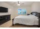Spacious bedroom with large windows and ceiling fan at 1103 White Water Bay Dr, Groveland, FL 34736