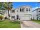 Two-story house with a white exterior and landscaped yard at 1103 White Water Bay Dr, Groveland, FL 34736