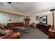 Finished basement with leather furniture, fireplace, and large TV at 6779 Clayton St, Mount Dora, FL 32757