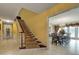 Elegant staircase with carpeting and wood railing at 6779 Clayton St, Mount Dora, FL 32757