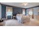 Charming bedroom with a white metal bed frame and blue floral wallpaper at 6779 Clayton St, Mount Dora, FL 32757