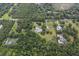 Aerial view showcasing a house with pool and surrounding landscape at 6779 Clayton St, Mount Dora, FL 32757