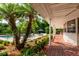 Relaxing poolside patio with brick pavers and tropical landscaping at 6779 Clayton St, Mount Dora, FL 32757