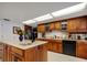 Kitchen with island, granite countertops, and wood cabinets at 6779 Clayton St, Mount Dora, FL 32757