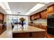 Spacious kitchen with granite countertops, island, and wood cabinets at 6779 Clayton St, Mount Dora, FL 32757