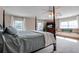 Spacious main bedroom with a four-poster bed and sitting area at 6779 Clayton St, Mount Dora, FL 32757