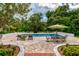Inviting pool area with patio furniture and lush landscaping at 6779 Clayton St, Mount Dora, FL 32757