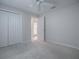Bedroom with double doors and access to bathroom at 2410 Little Mountain Loop, The Villages, FL 32162